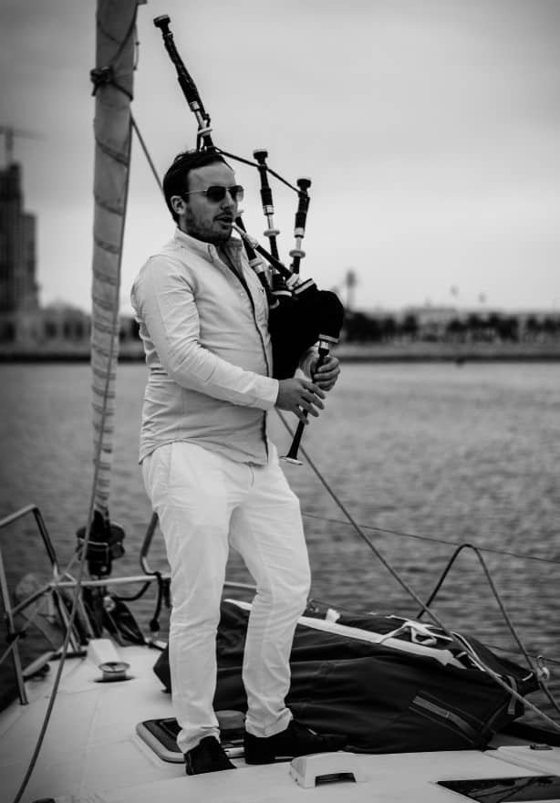 Medium close up shot of playing bagpipes on yacht