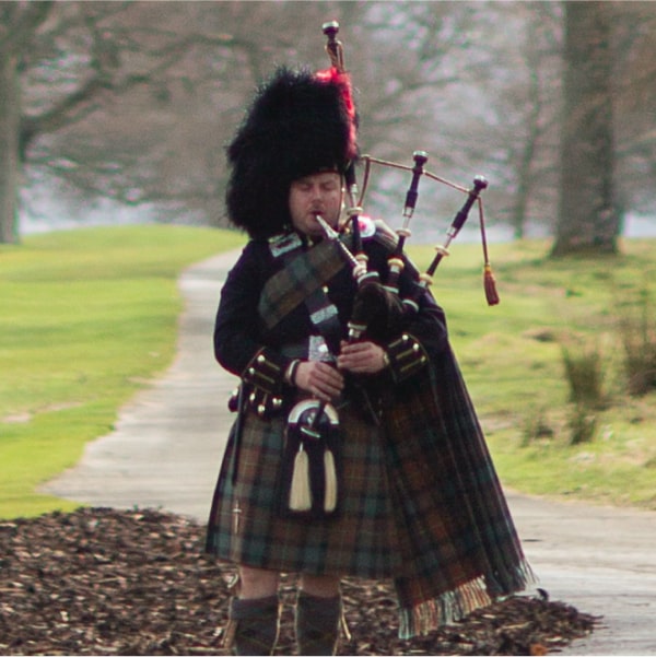 Playing bagpipes in full Highland Dress